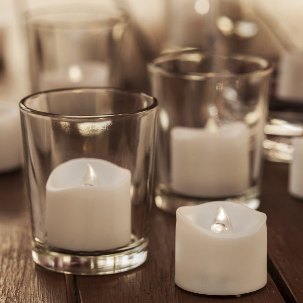 battery-operated candles in clear glasses